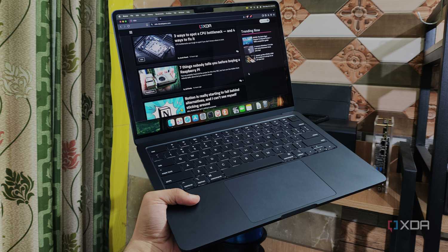 A person holding a MacBook Air M4