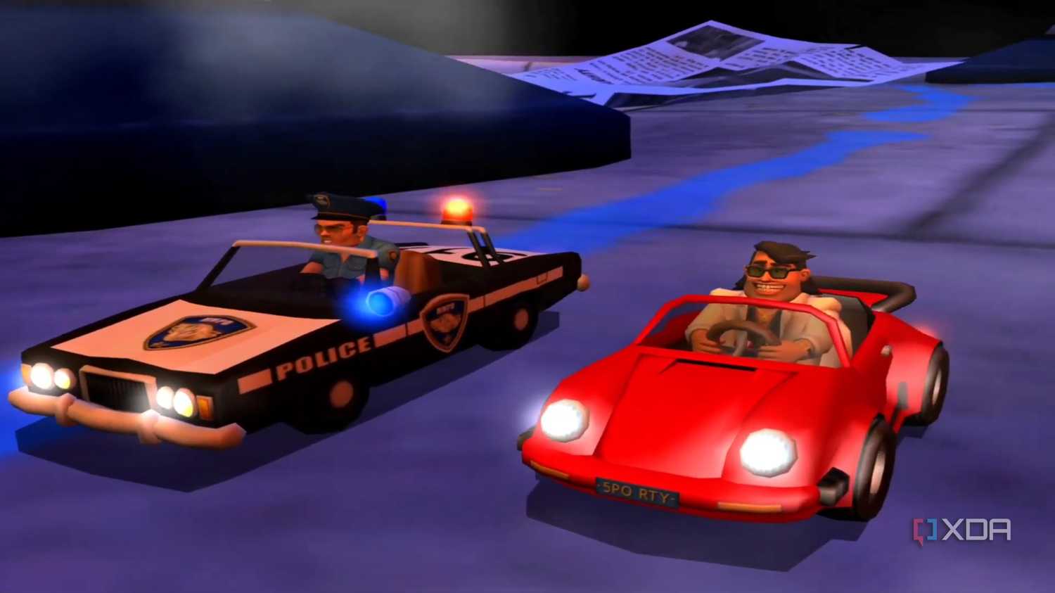 A screenshot from the game Micro Machines, showing a police car and a red coupe ready to race each other.
