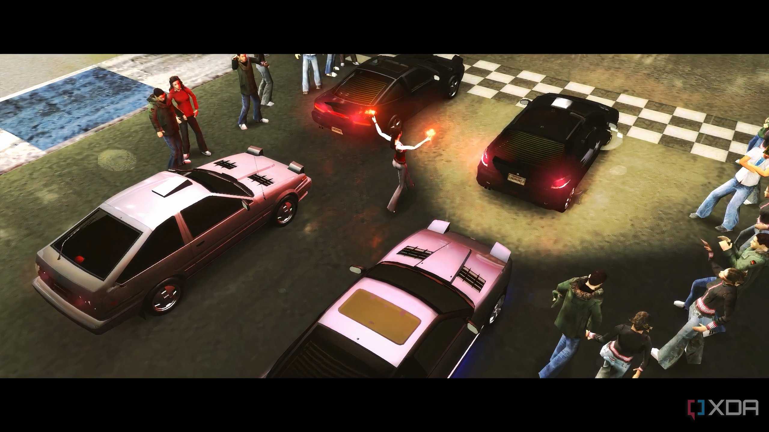 A screenshot from the game Need for Speed: Underground 2, showing cars readying up for a race.
