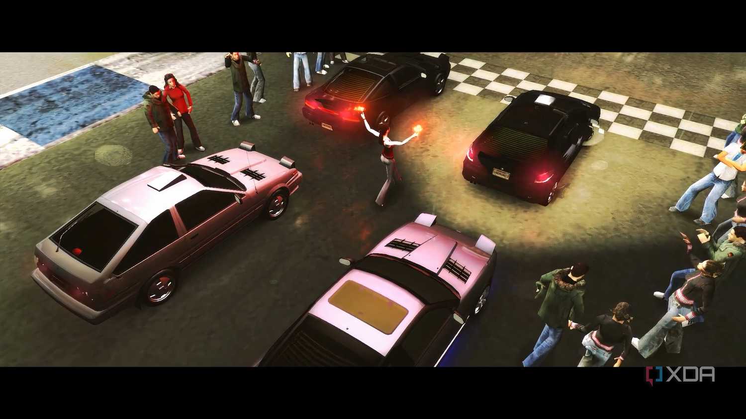 A screenshot from the game Need for Speed: Underground 2, showing cars readying up for a race.