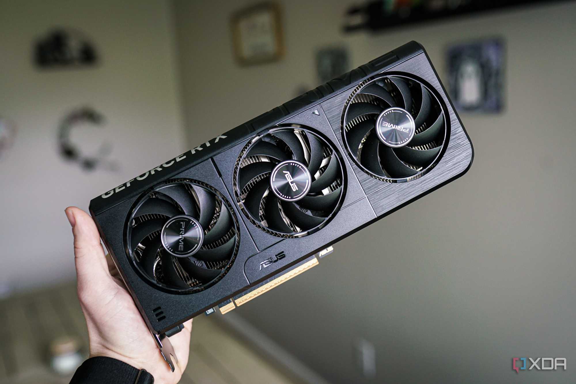 A hand holding the Nvidia GeForce RTX 5060.