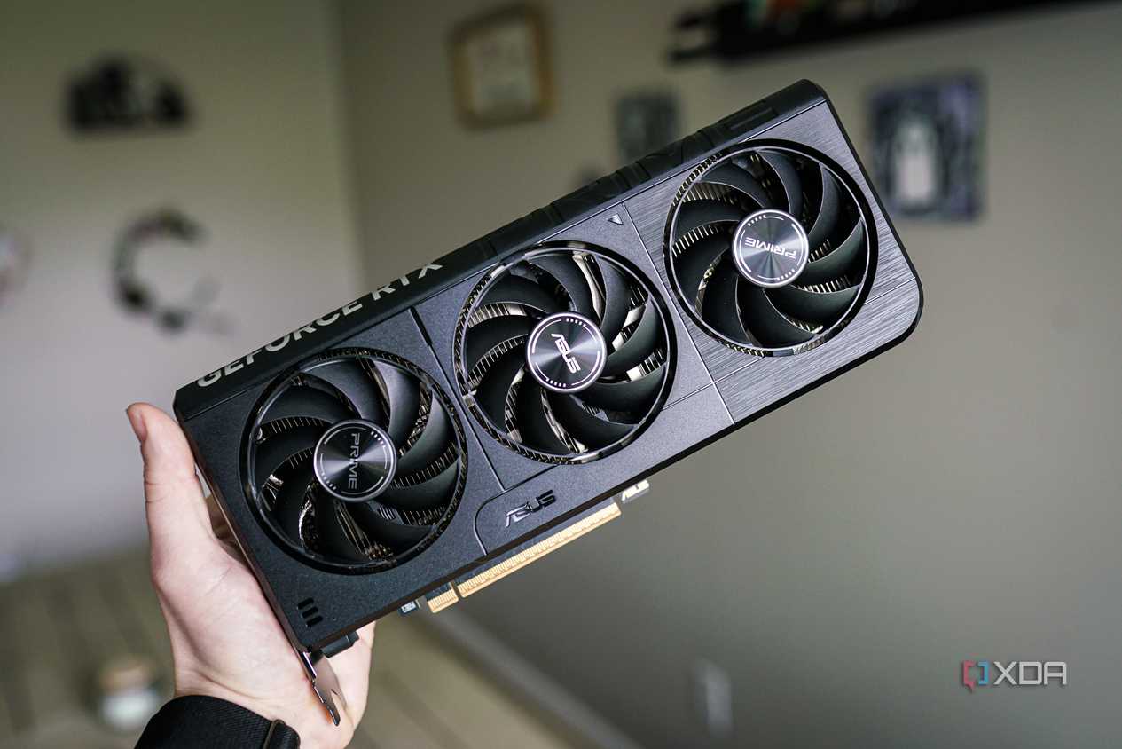 A hand holding the Nvidia GeForce RTX 5060.