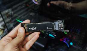 A hand holding an NVMe enclosure.