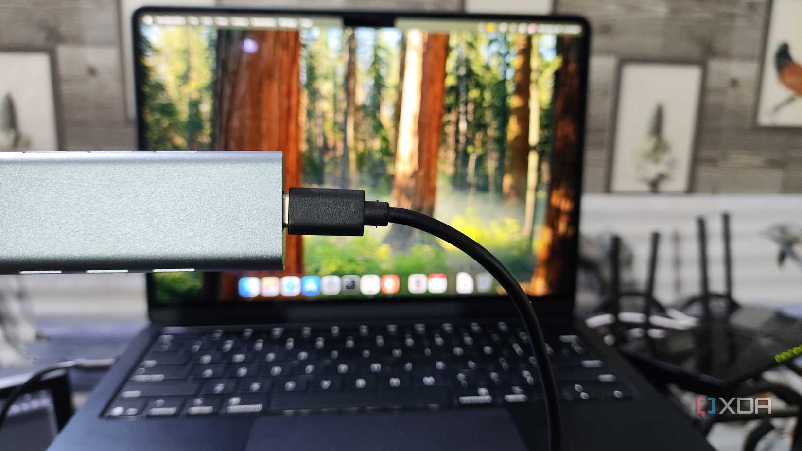 Holding an NVMe enclosure in front of a MacBook