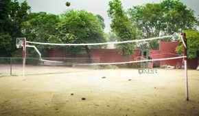 A photograph of a high-school volleyball court.