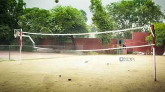 A photograph of a high-school volleyball court.