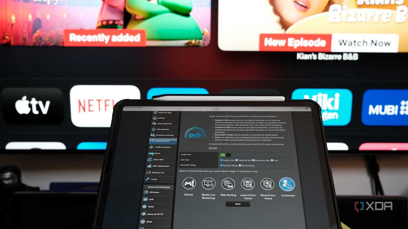 Photo of QoS Settings of ASUS router on iPad in front of a TV