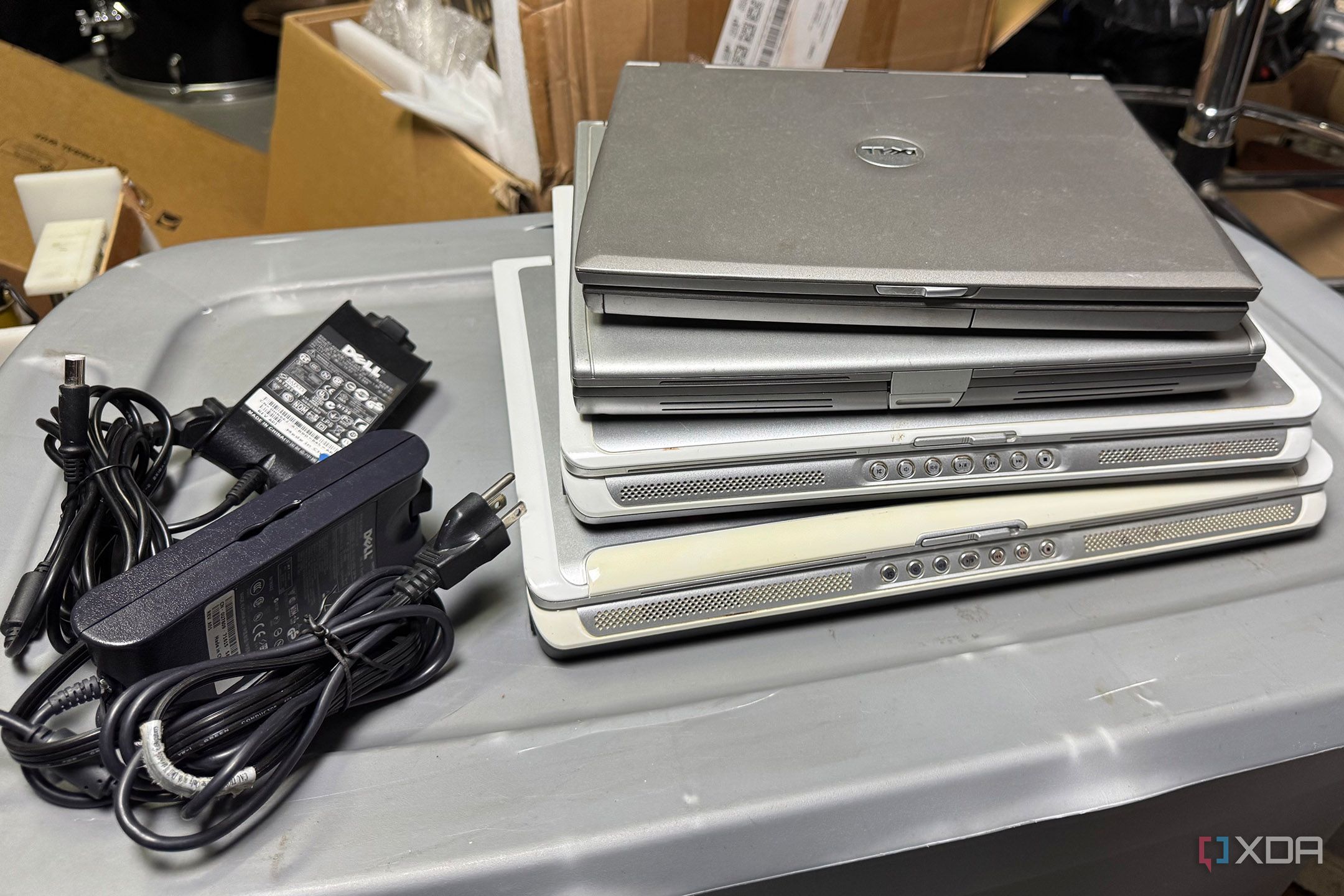 Stack of old laptops and power supplies