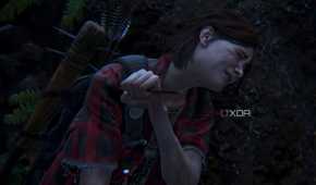 Ellie wincing in pain while removing an arrow from her shoulder in The Last of Us Part II.
