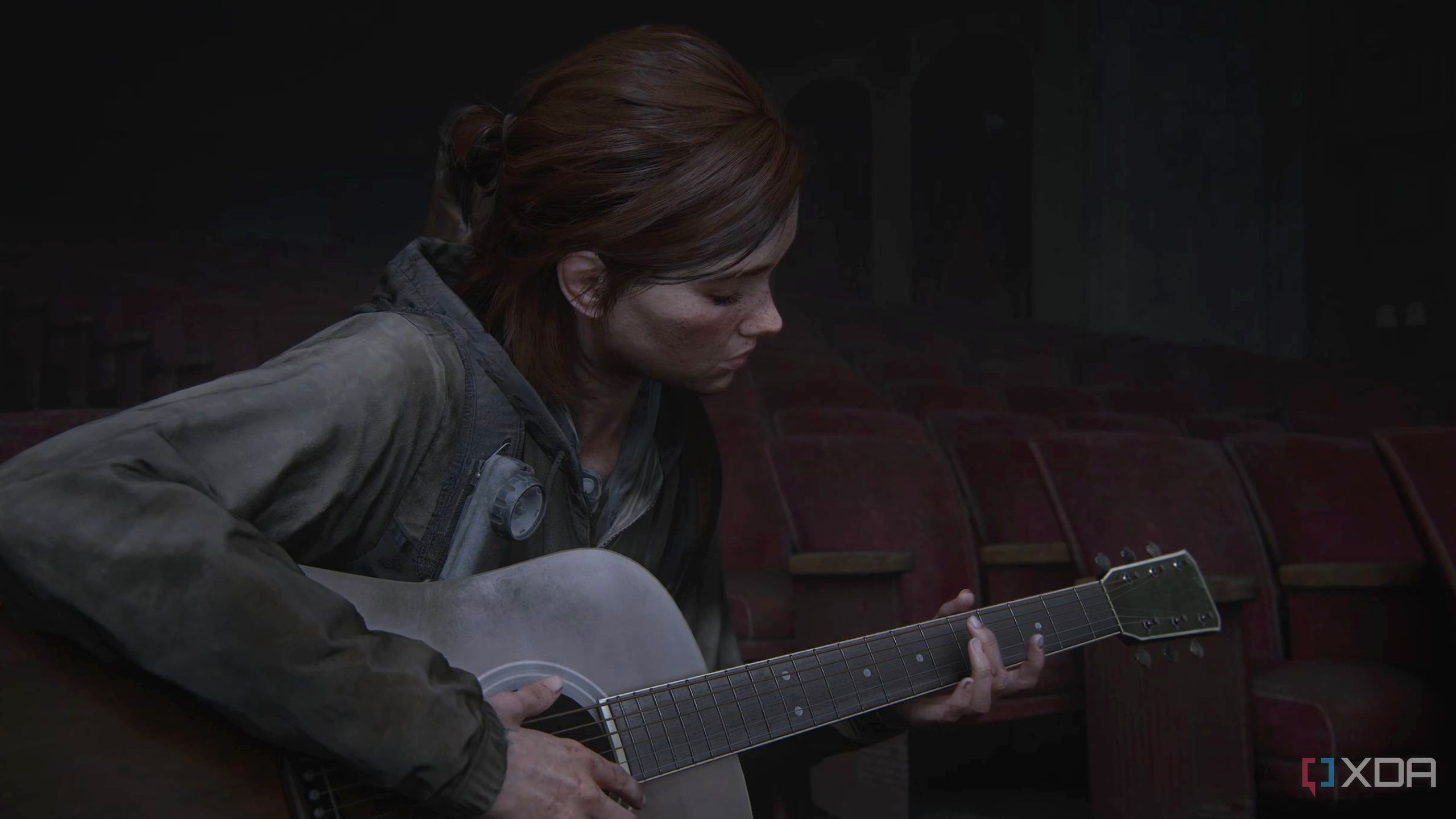 Ellie playing the guitar in The Last of Us Part II.