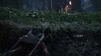 Ellie hiding from Seraphites with flaming torches in The Last of Us Part II.