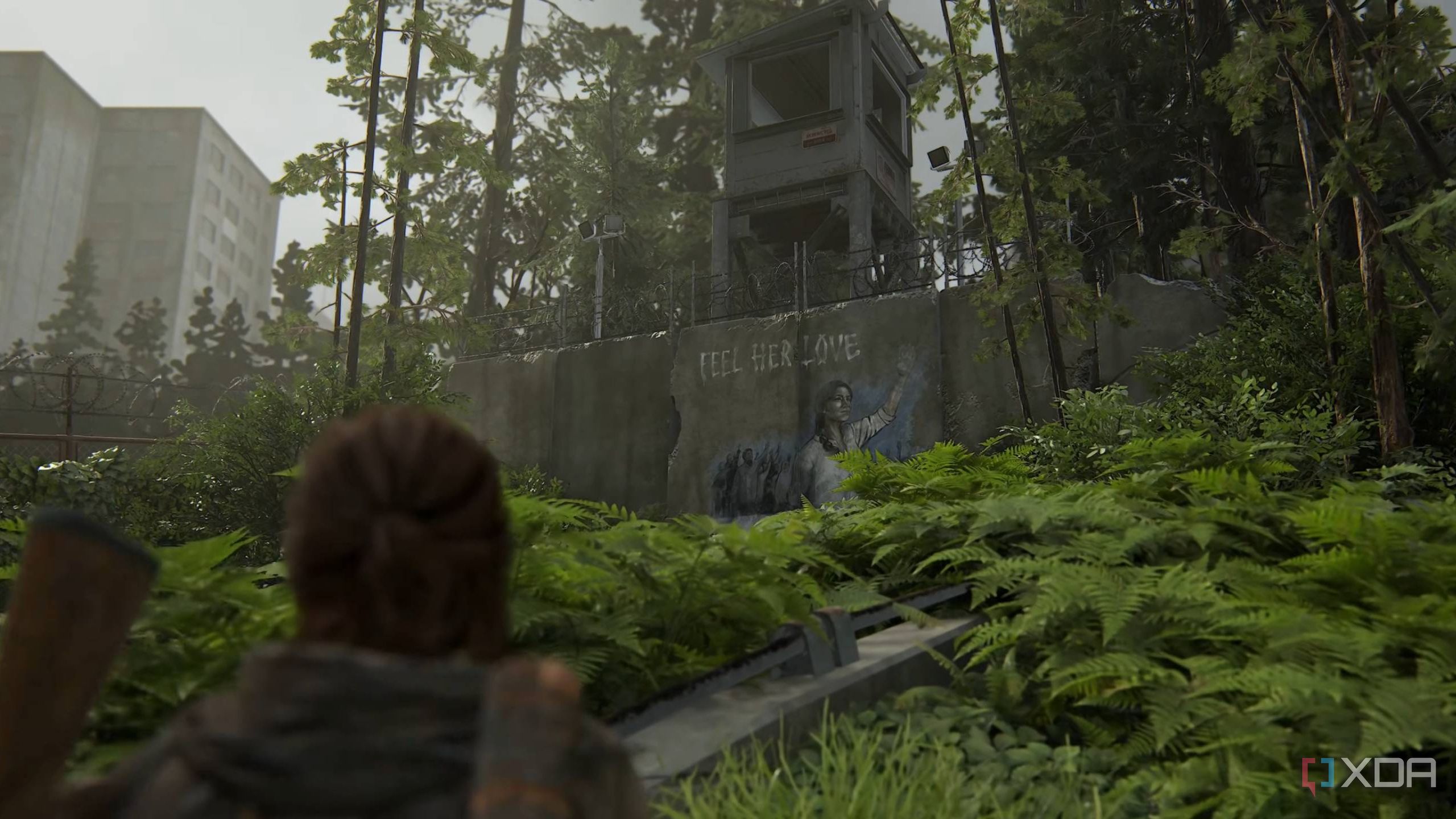 Ellie looking at a Seraphite mural in The Last of Us Part II Remastered.