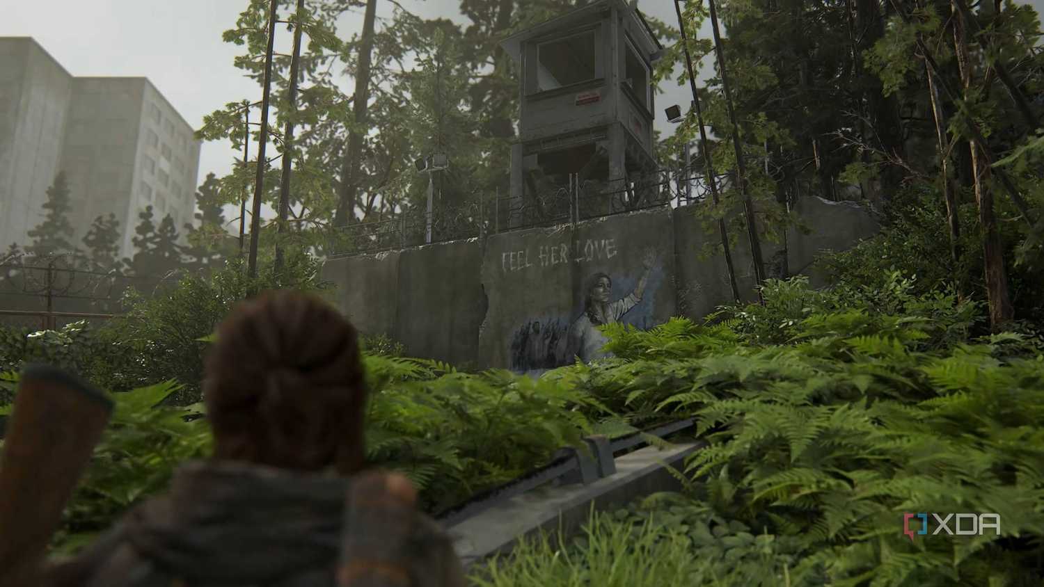 Ellie looking at a Seraphite mural in The Last of Us Part II Remastered.