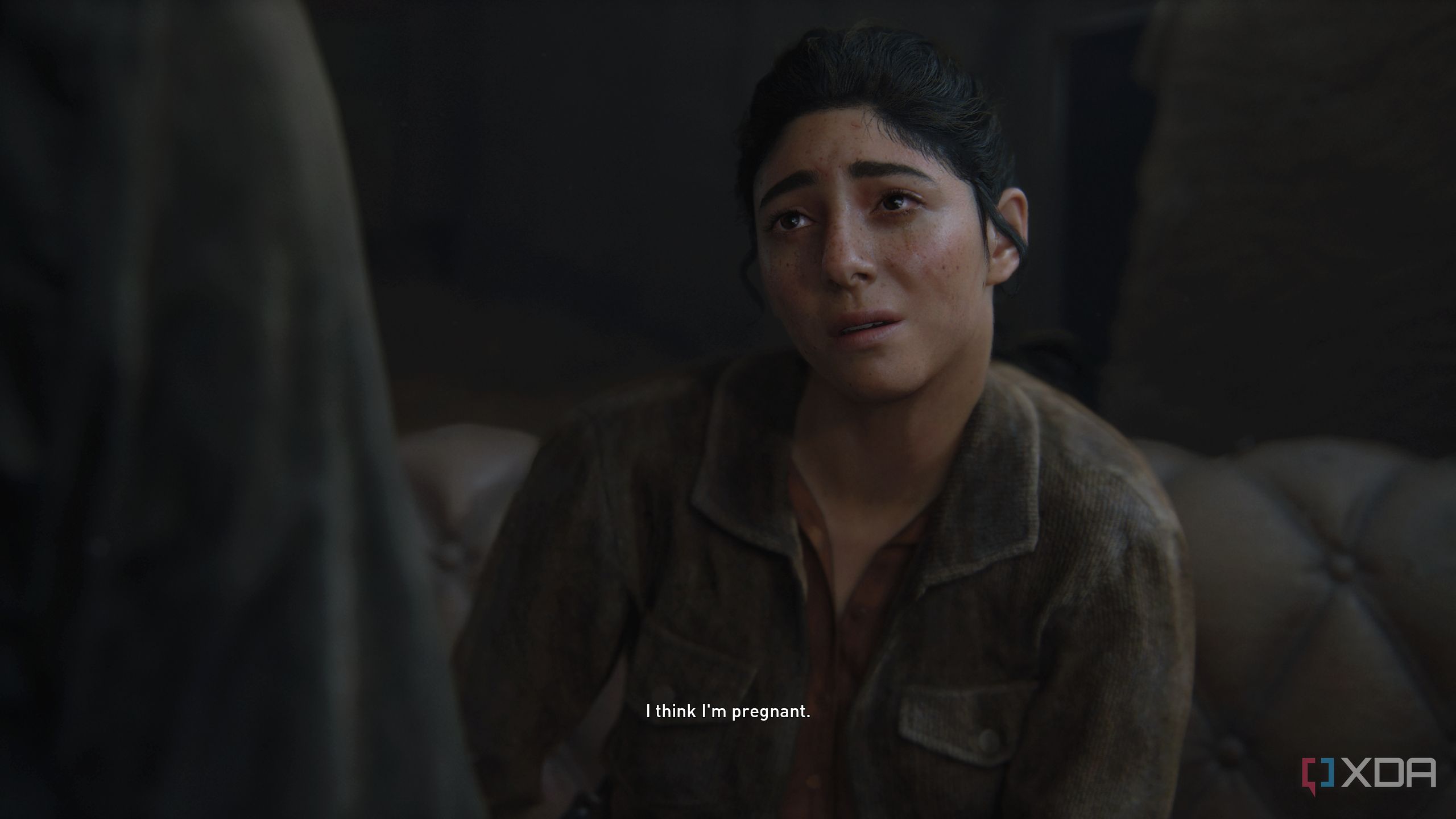 An image from the game The Last of Us Part II Remastered on PC, showing Dina crying while telling Ellie that she's pregnant.