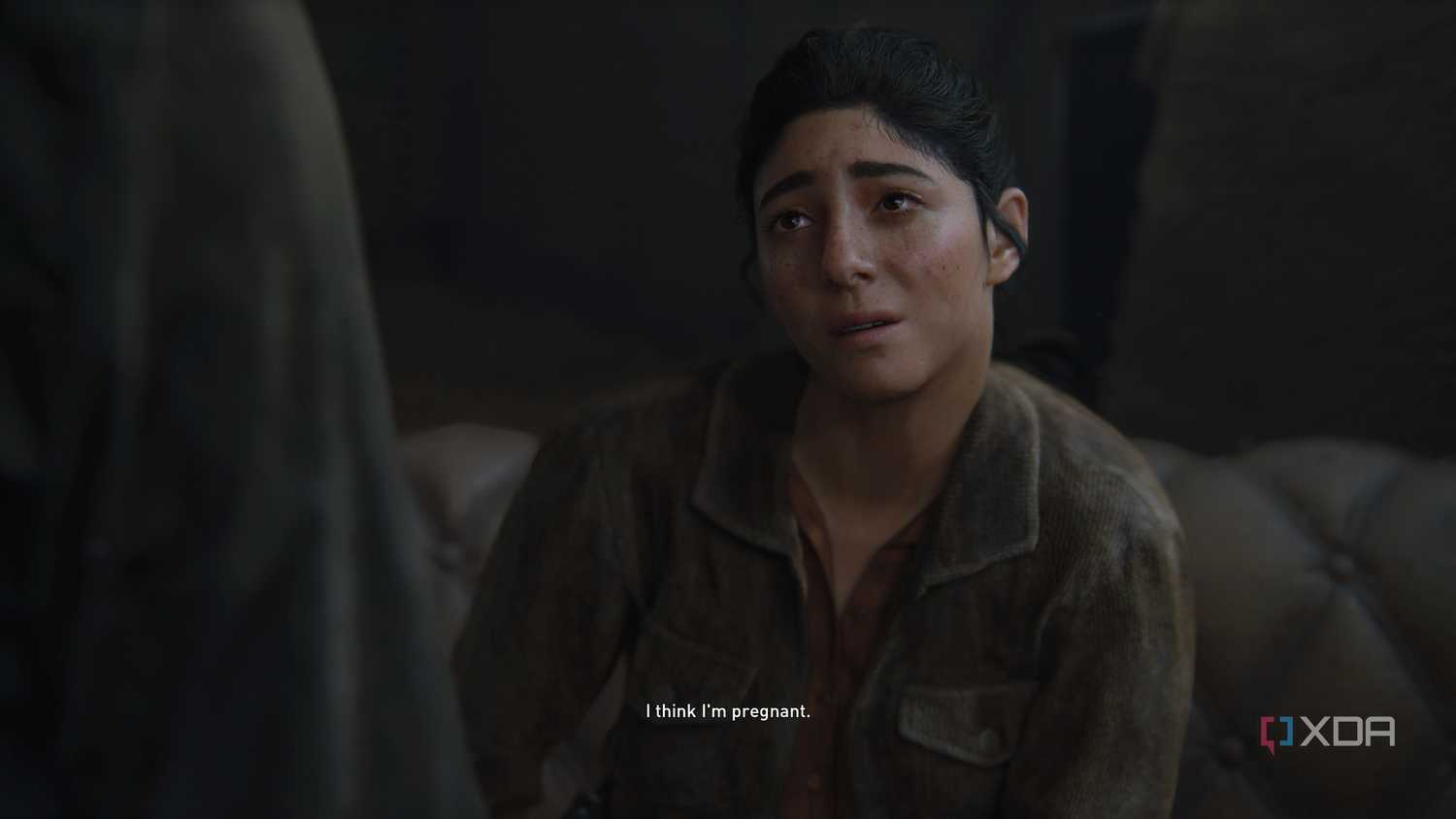 An image from the game The Last of Us Part II Remastered on PC, showing Dina crying while telling Ellie that she's pregnant.