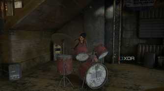 An image from the game The Last of Us Part II Remastered on PC, showing Dina playing the drums in a music shop.
