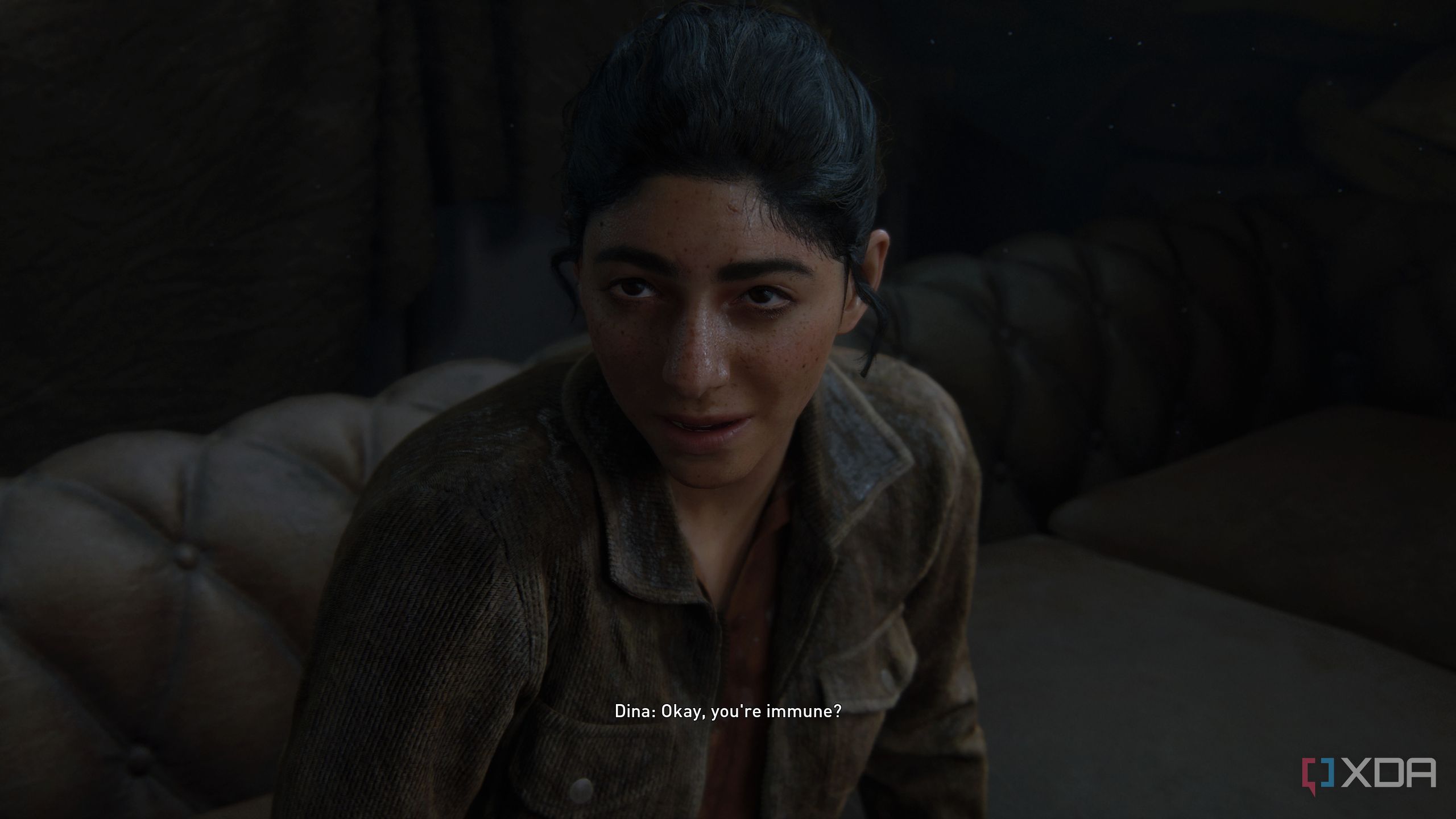 An image from the game The Last of Us Part II Remastered on PC, showing Dina scoffing at Ellie.