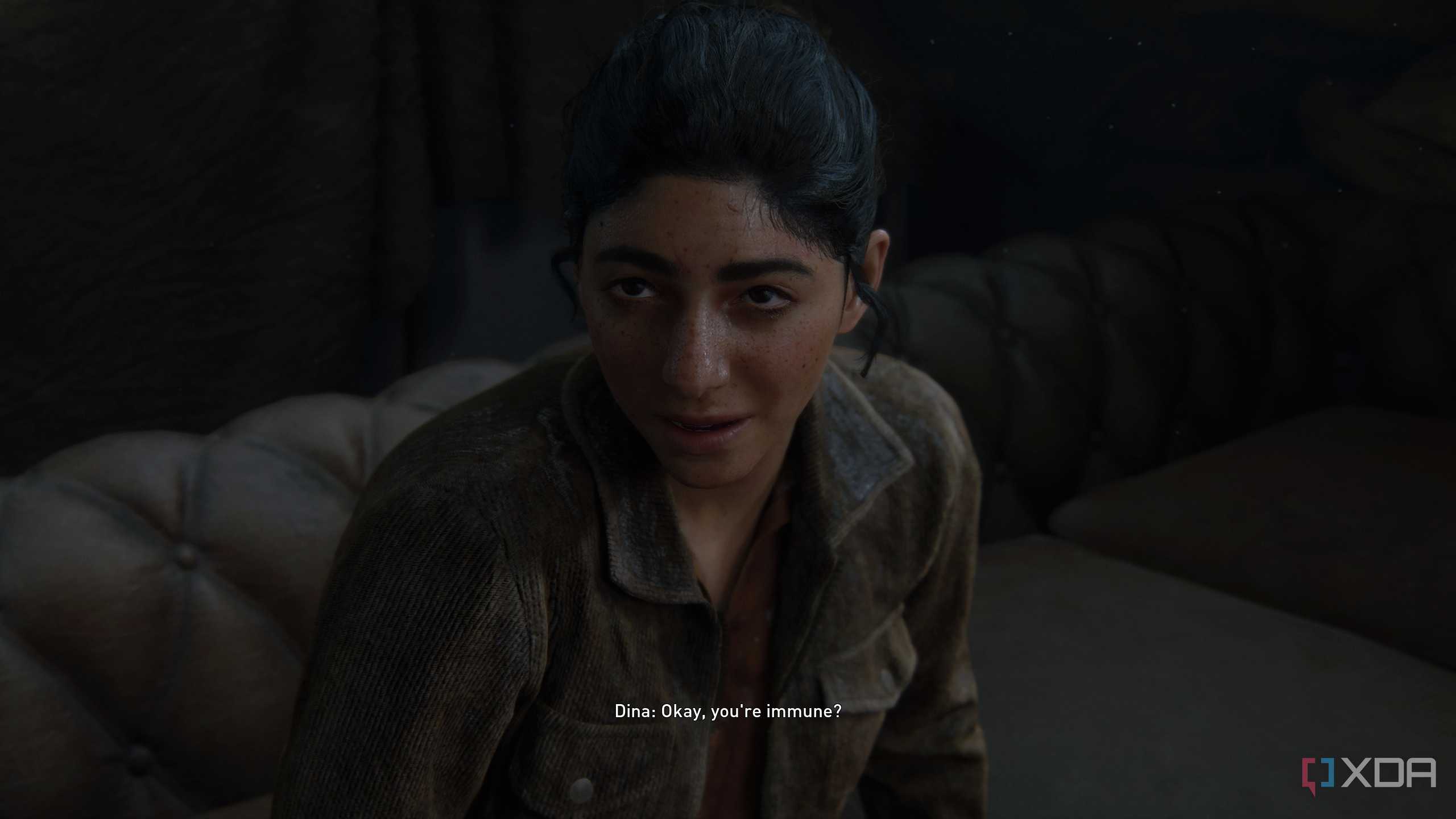 An image from the game The Last of Us Part II Remastered on PC, showing Dina scoffing at Ellie.