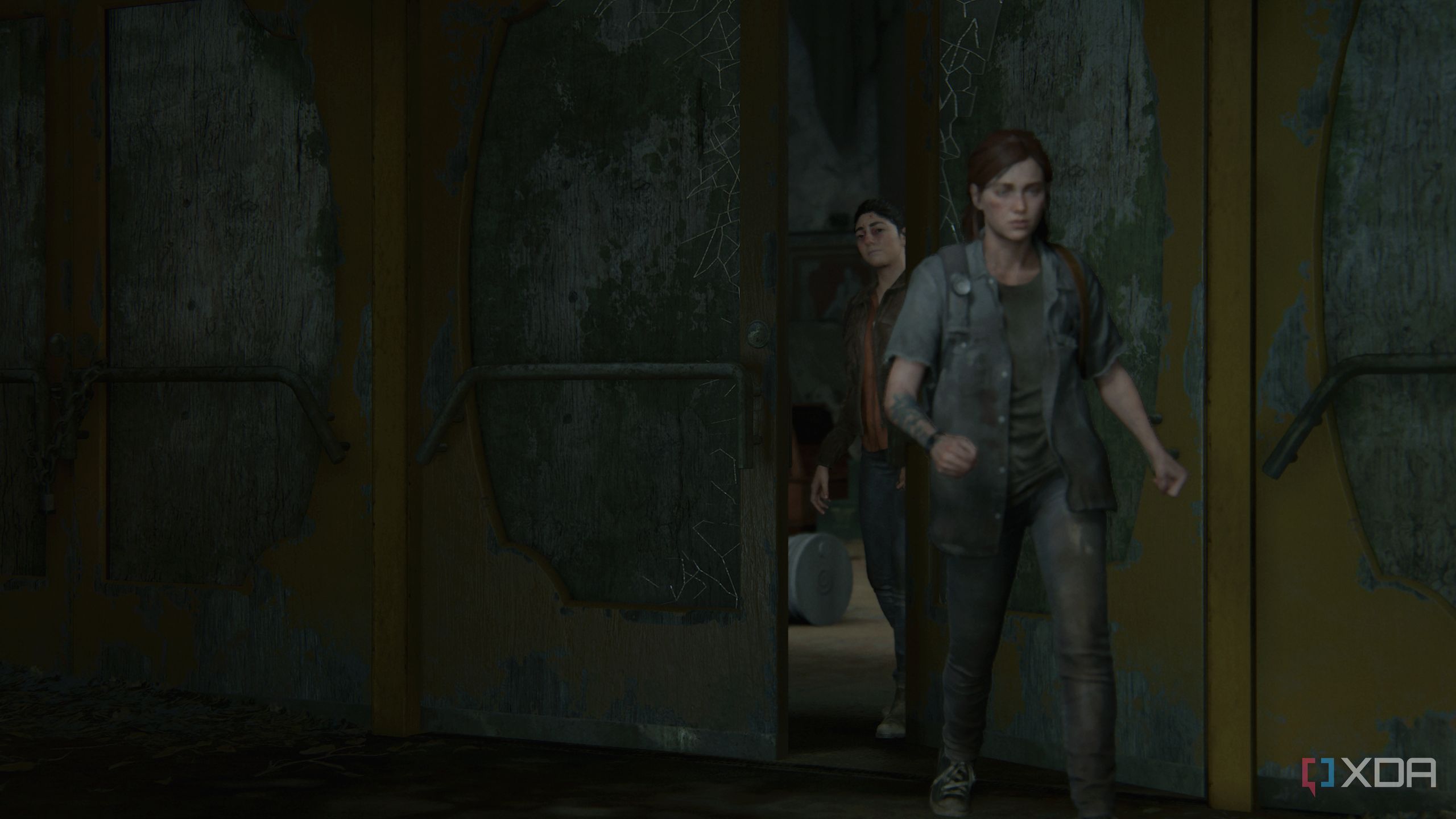 Ellie leaving the hideout while Dina closes the door behind her.