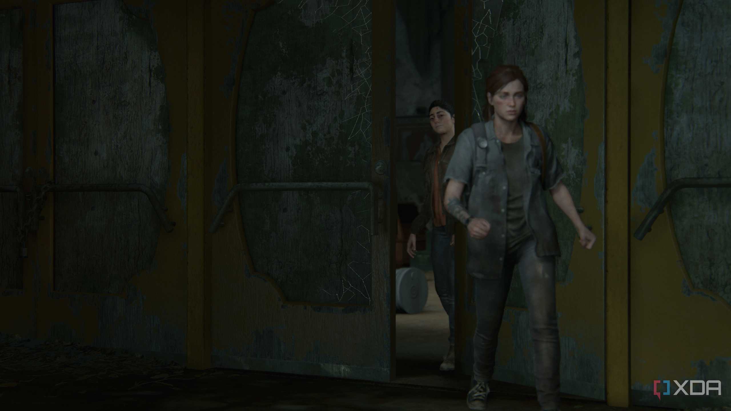 Ellie leaving the hideout while Dina closes the door behind her.