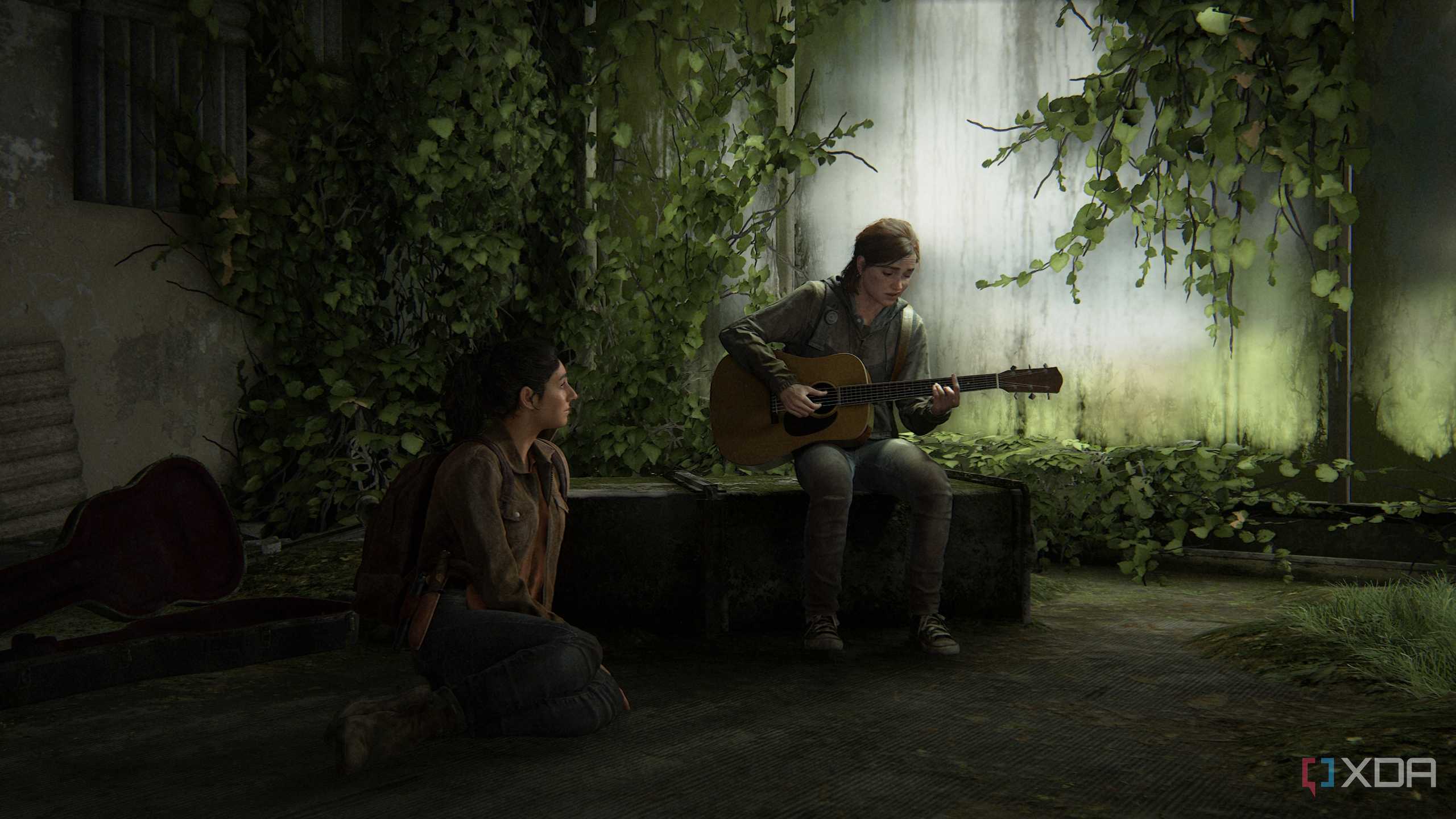 Ellie playing the guitar while Dina sits on the floor, listening.