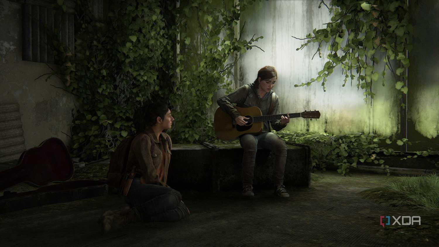 Ellie playing the guitar while Dina sits on the floor, listening.