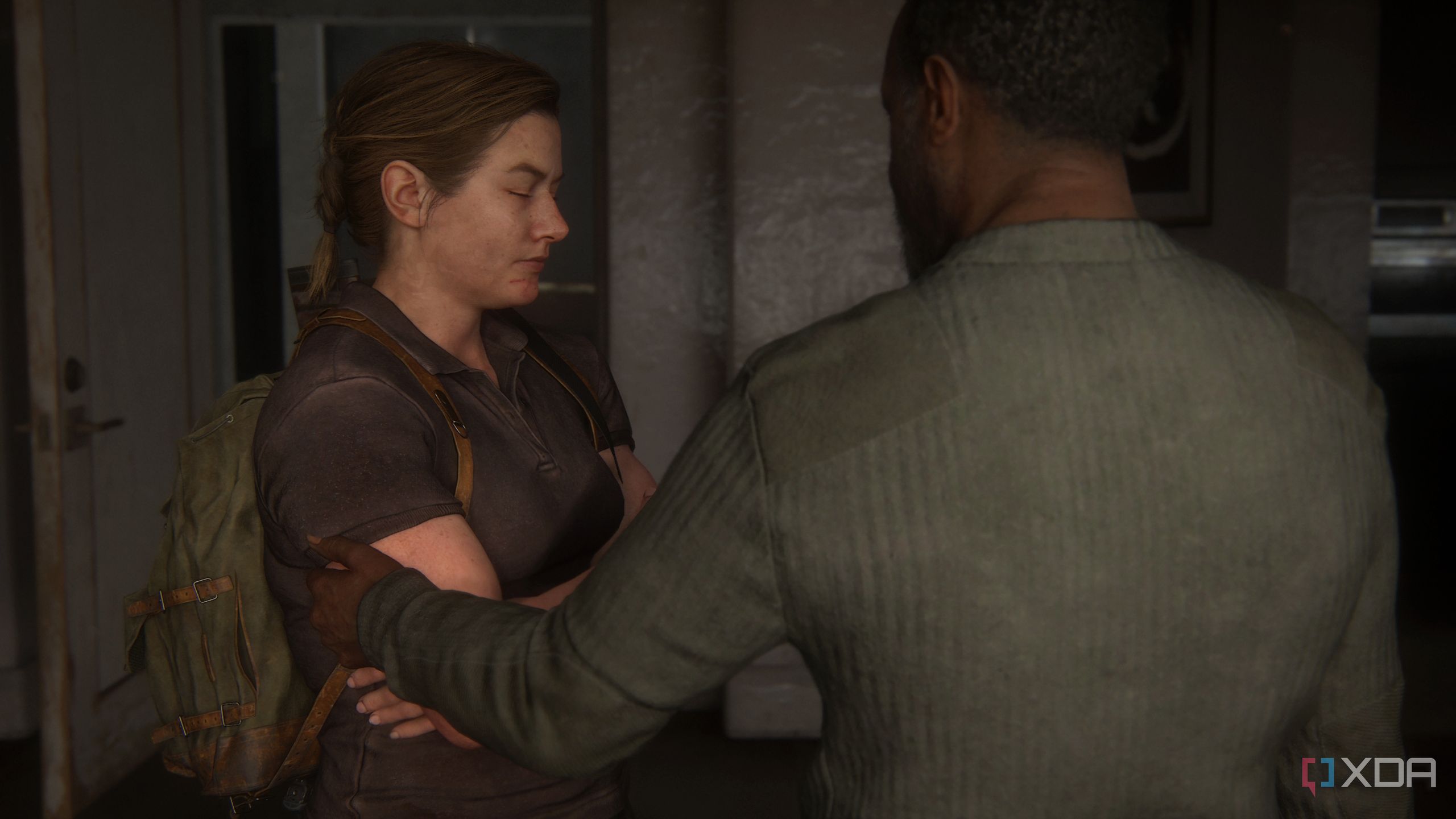 An image from the game The Last of Us Part II Remastered on PC, showing Isaac touching Abby's arm.