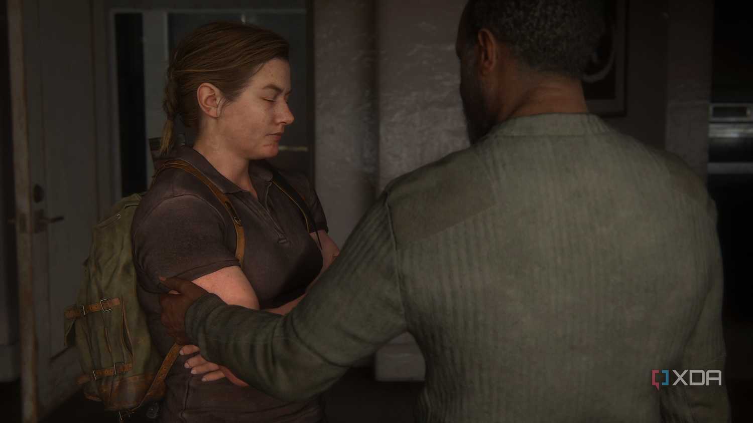 An image from the game The Last of Us Part II Remastered on PC, showing Isaac touching Abby's arm.