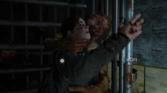 An image from the game The Last of Us Part II Remastered on PC, showing a clicker attacking Ellie through a revolving gate.