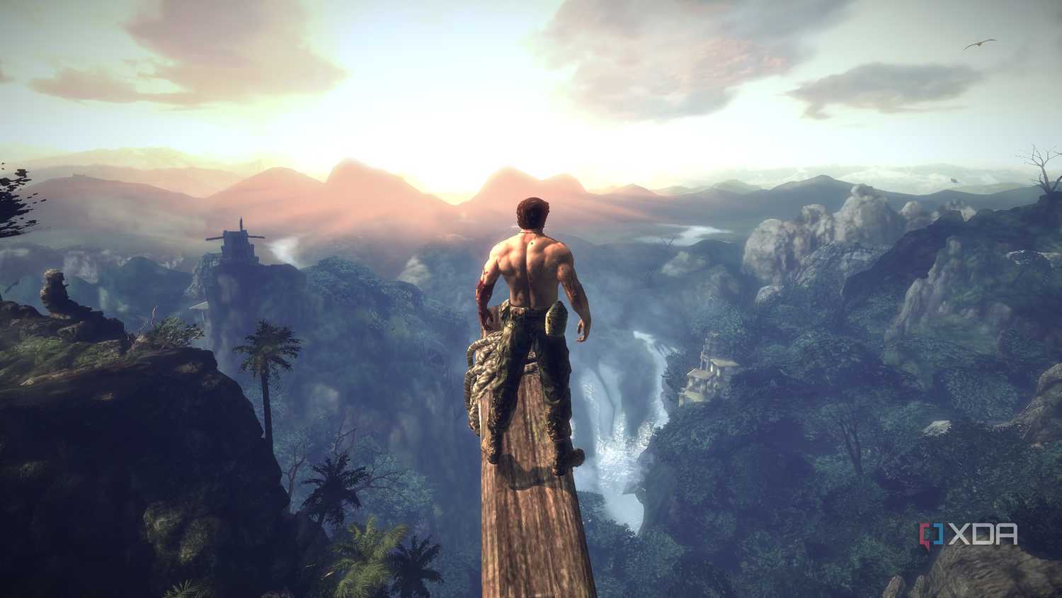Logan standing on a wooden beam, taking in a setting sun in X-Men Origins: Wolverine.