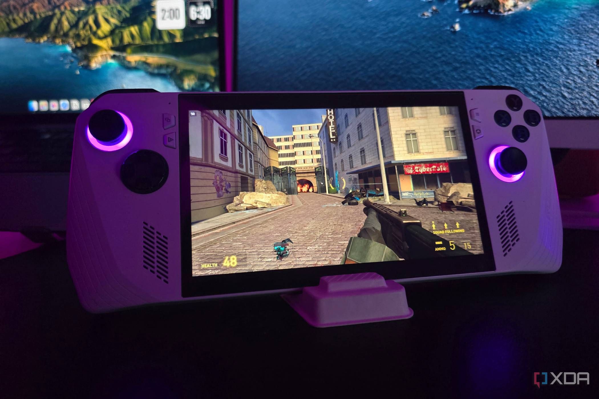 Asus ROG Ally running Half-Life 2 with a MacBook and a monitor in the background