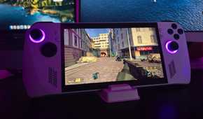 Asus ROG Ally running Half-Life 2 with a MacBook and a monitor in the background