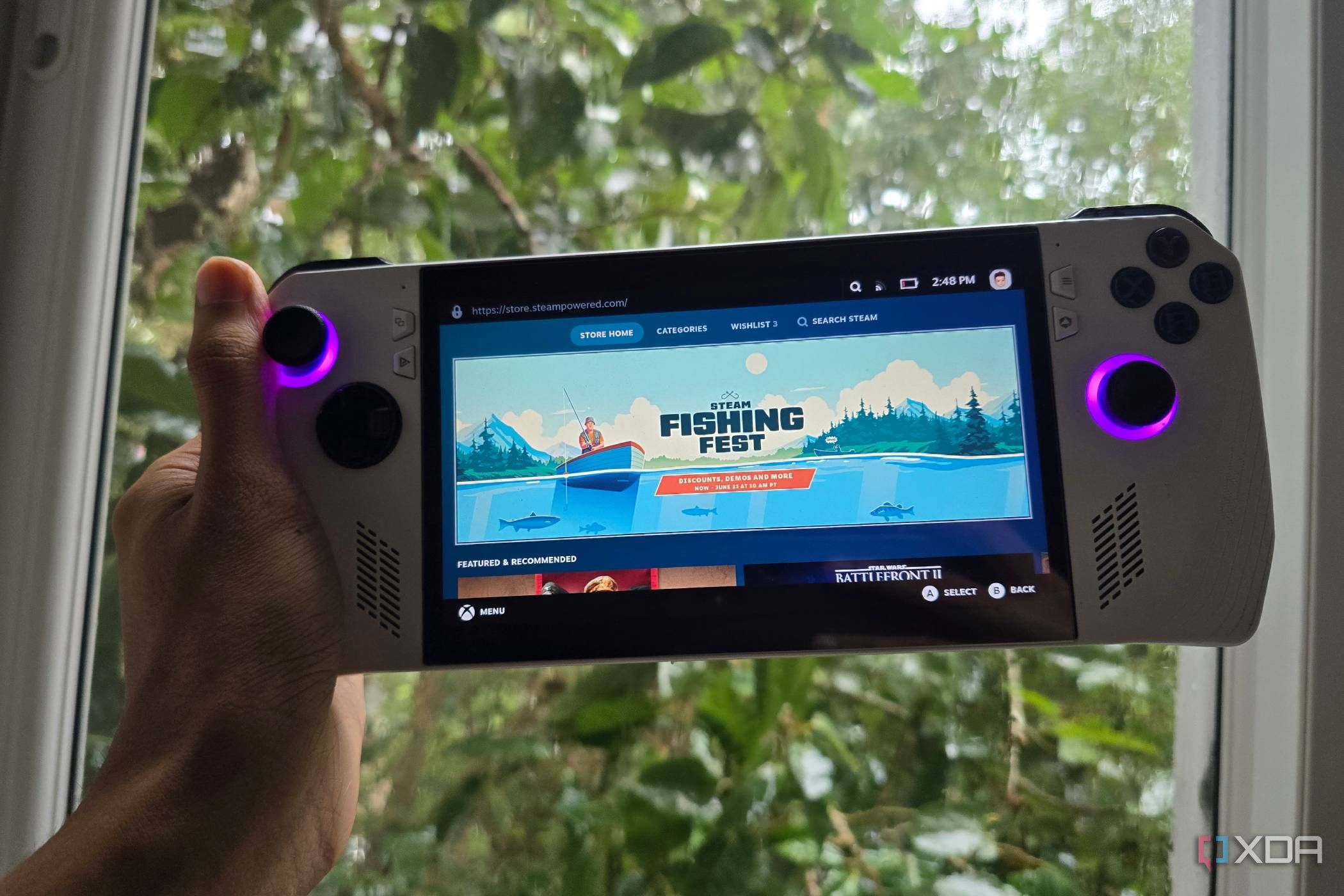 A person holding an Asus ROG Ally running SteamOS with the store page open