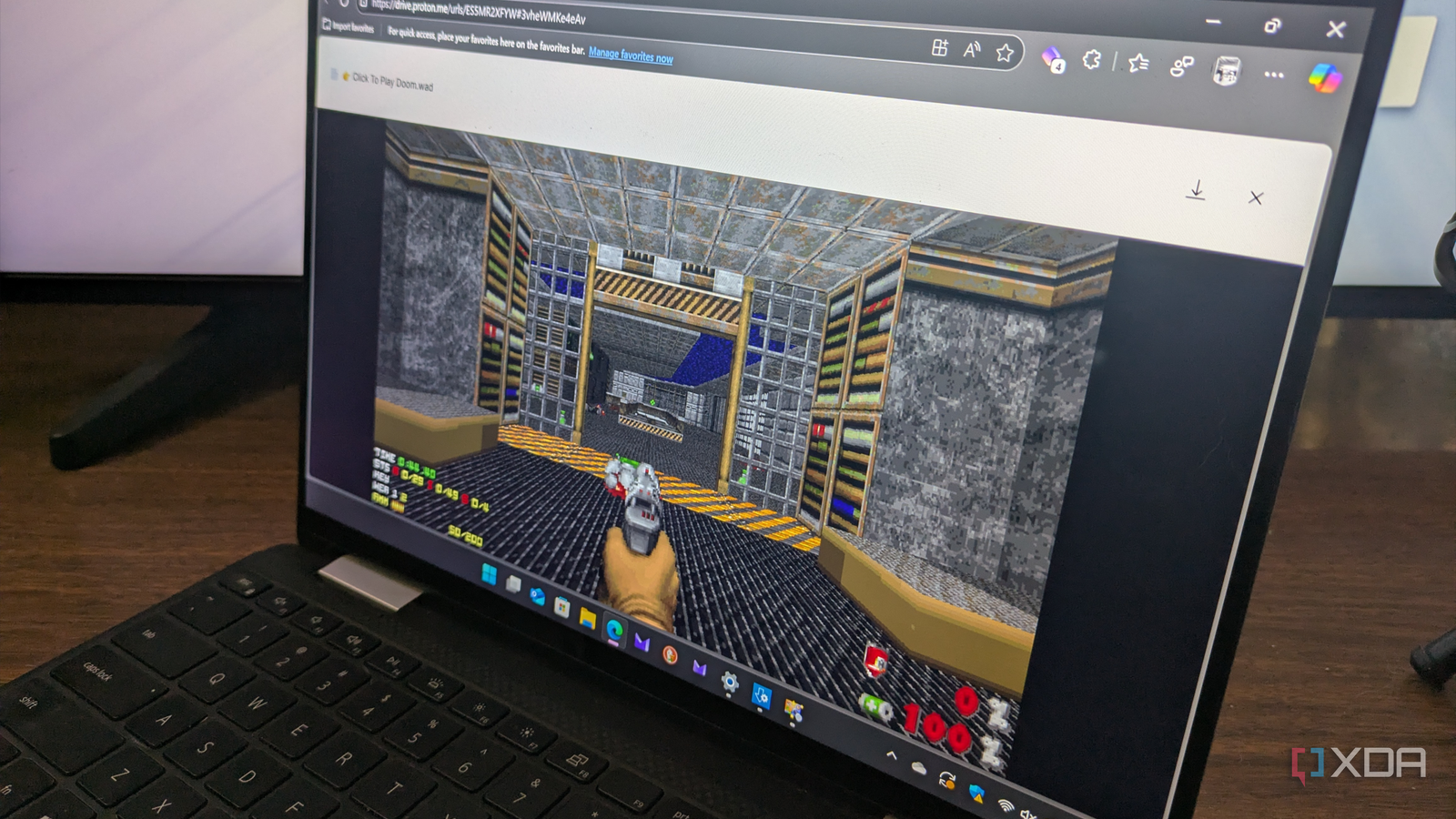 Shows playing Doom via Proton Drive on laptop