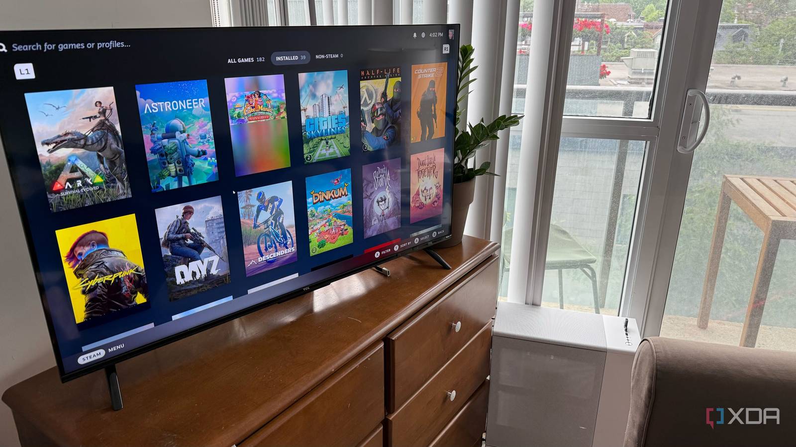 A photo of a PC connected to a TV, showing Steam
