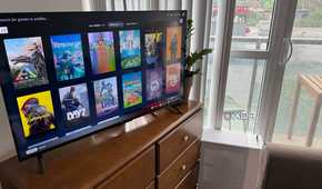 A photo of a PC connected to a TV, showing Steam