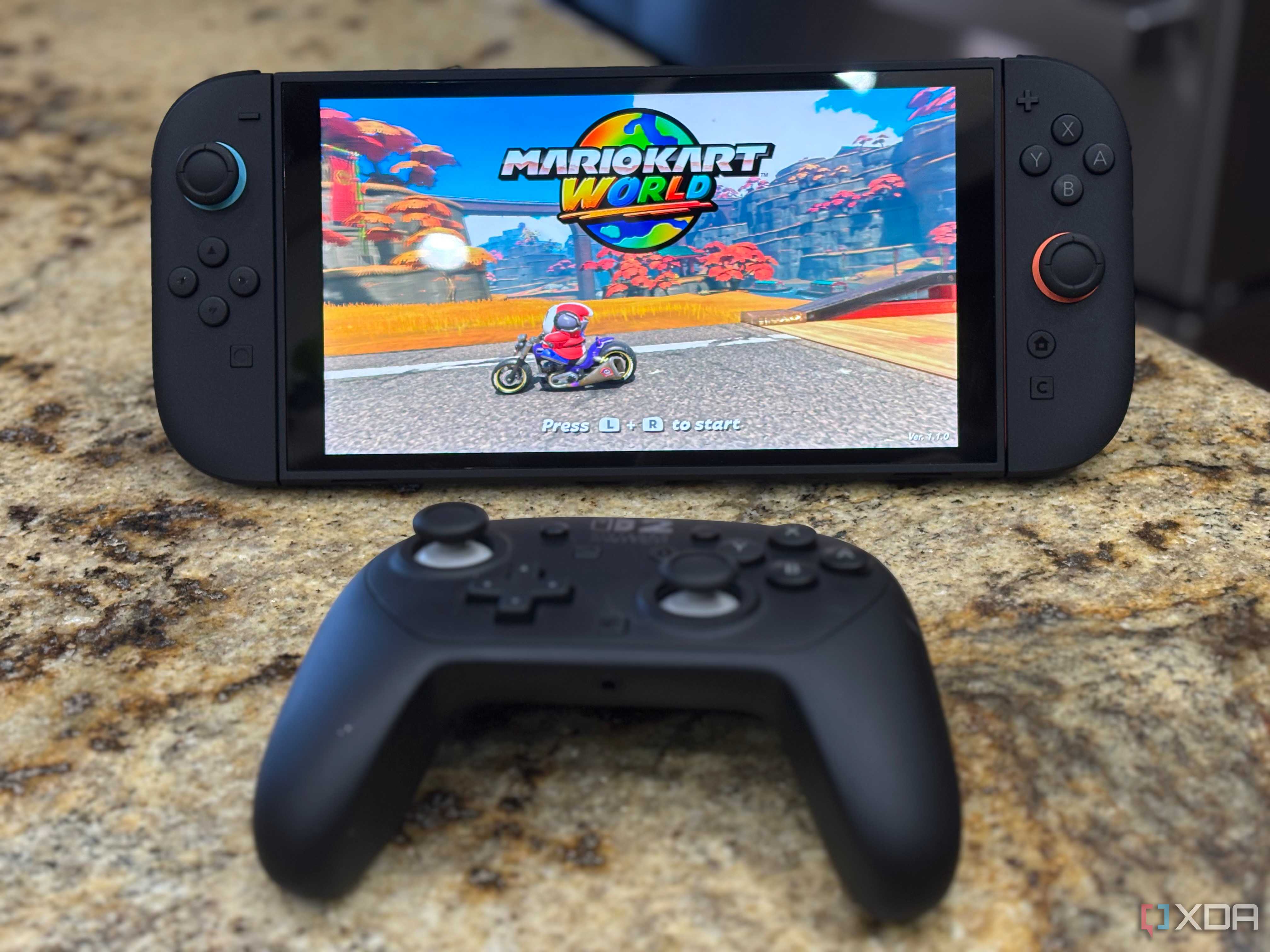 A switch 2 with a pro controller in front of it while playing mario kart