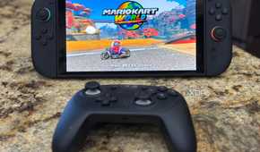 A switch 2 with a pro controller in front of it while playing mario kart
