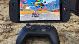 A switch 2 with a pro controller in front of it while playing mario kart