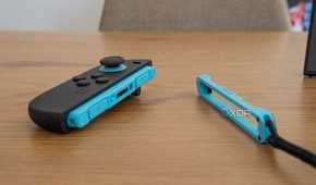 A Joy-Con 2 next to its strap to be used in mouse mode