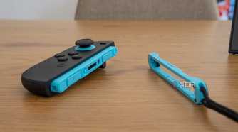 A Joy-Con 2 next to its strap to be used in mouse mode