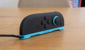 A Joy-Con 2 with its strap attached laying horizontally to be used as a mouse