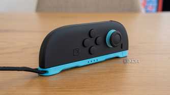 A Joy-Con 2 with its strap attached laying horizontally to be used as a mouse