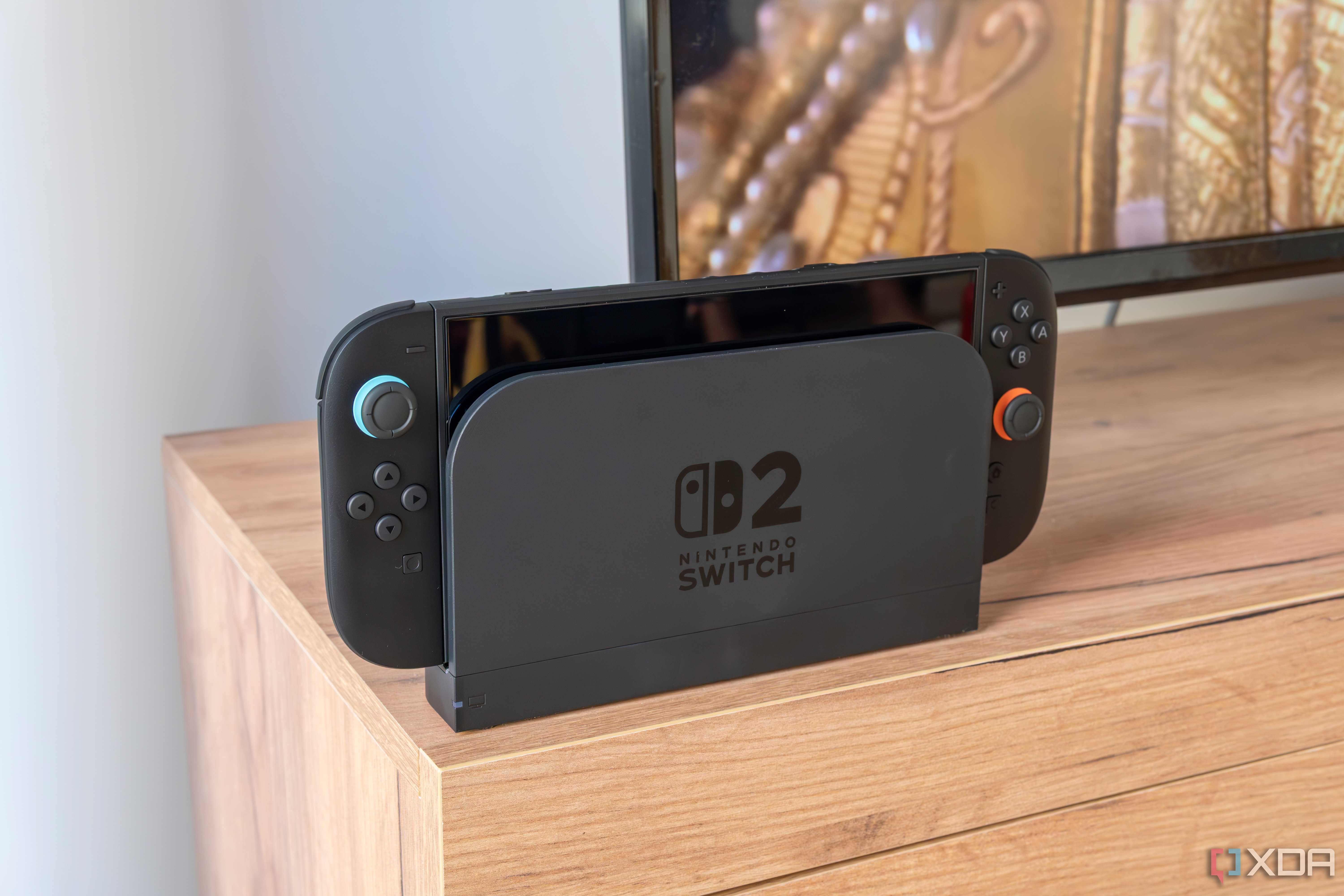 A Nintendo Switch 2 in its dock in front of a TV