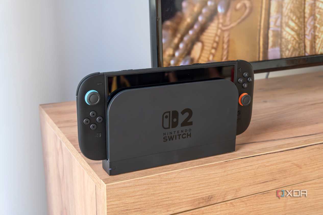 A Nintendo Switch 2 in its dock in front of a TV