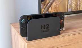 A Nintendo Switch 2 in its dock in front of a TV