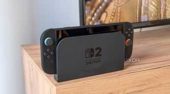 A Nintendo Switch 2 in its dock in front of a TV