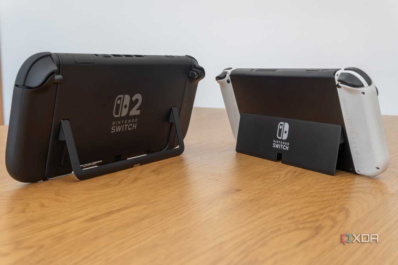 Angled rear view of a Nintendo Switch 2 and a Nintendo Switch OLED model showing both kickstand in use