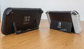 Angled rear view of a Nintendo Switch 2 and a Nintendo Switch OLED model showing both kickstand in use