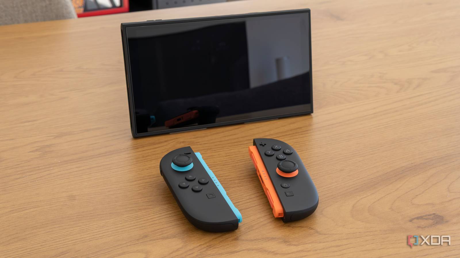 A Nintendo Switch 2 in tabletop mode with detached Joy-Con 2 controllers in front of it